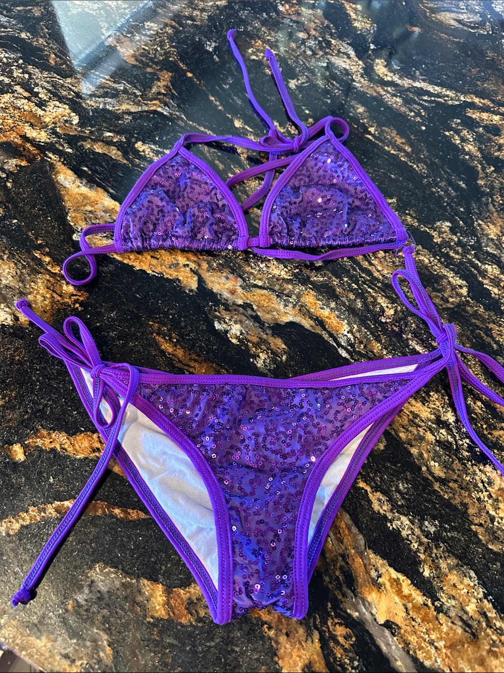 Dippin Daisy’s purple sequin string bikini set